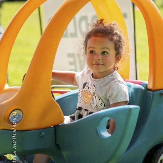 Girl in toy tractor courtesy of Restore Hope